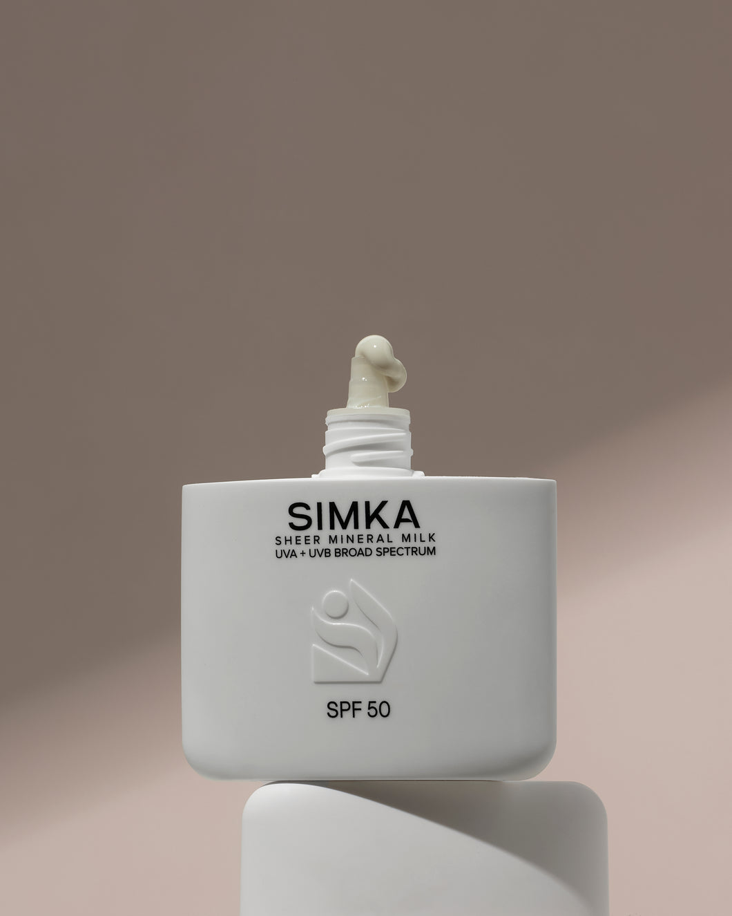 SIMKA sunscreen bottle on a gradient background