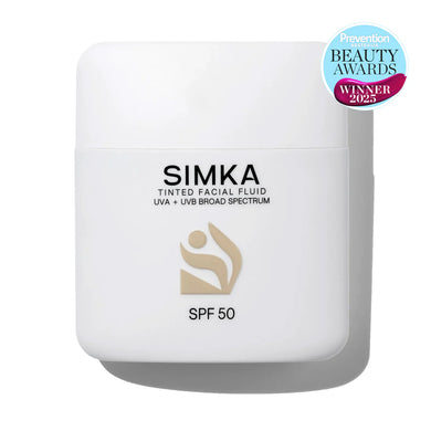 Simka tinted facial fluid container with SPF 50 on a white background