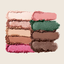 Makeup palette with various shades of eyeshadow on a light background
