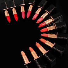 Collection of lipsticks in various shades on a black background with 'YSL' branding.