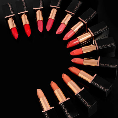 Collection of lipsticks in various shades on a black background with 'YSL' branding.