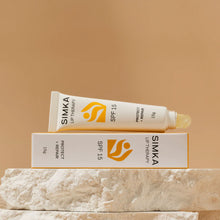 SIMKA lip therapy tube and packaging on a beige background